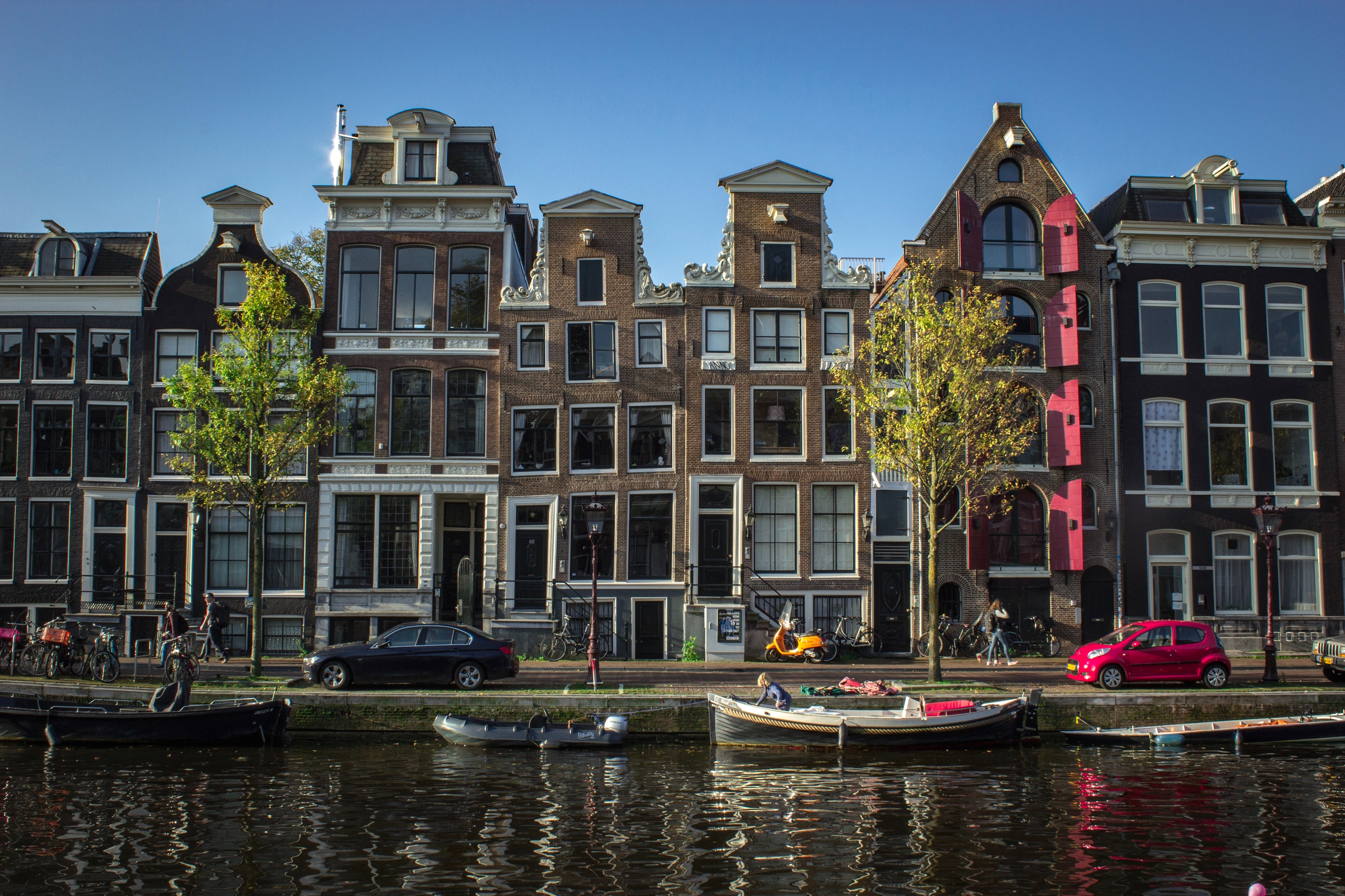 typical houses by a canal in the Jordaan neighbourhood in Amsterdam, the Netherlands