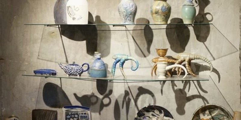 Hands crafting a vase in a ceramics studio