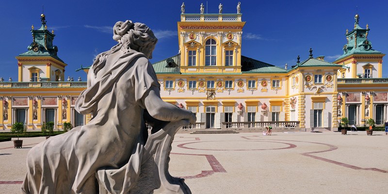 statue in front of an ornate palace