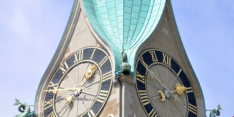 Beautiful aerial view of the St. Peter church in the city of Zurich in Switzerland and its iconic churches, buildings rivers and Clockes.